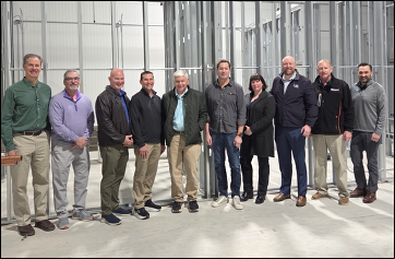 Leadership from Three Roots Capital poses for a picture with the Custom Foods of America team inside their Knoxville manufacturing location.